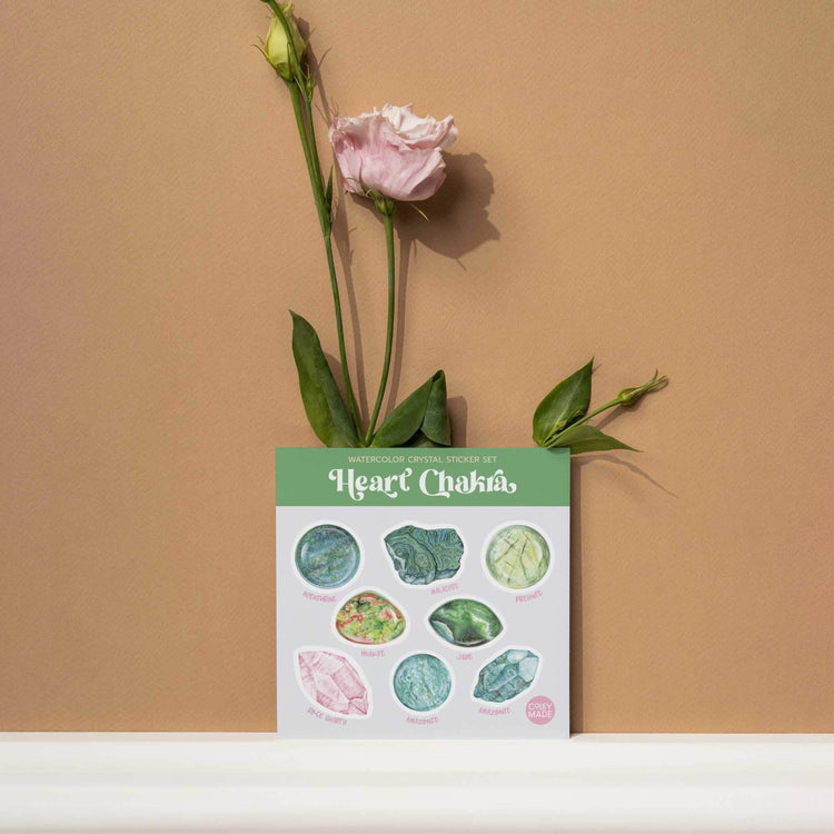 a heart chakra watercolor crystal sticker set with a flower in a vase on a shelf