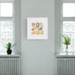 Solar Plexus Chakra Watercolor Crystal Art Print framed and hanging between two windows on a green wall