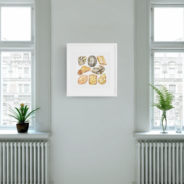 Solar Plexus Chakra Watercolor Crystal Art Print framed and hanging between two windows on a green wall