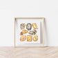 a white wall with a wooden frame holding a picture of the solar plexus Chakra Watercolor Crystal Art Print