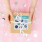 a person holding a gift box with a ribbon with the Throat Chakra Crystal Sticker Set