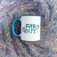 a blue and white coffee mug with the word far out on it