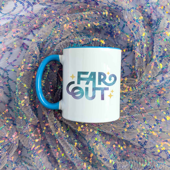 a blue and white coffee mug with the word far out on it