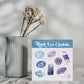 a plant in a vase with the Third Eye Chakra Crystal Sticker Set next to it