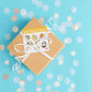 a box with a ribbon tied around it with Solar Plexus Chakra Crystal Sticker sheet on a blue background