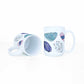 a white coffee mug with a picture watercolor crystals representing the 7 chakras