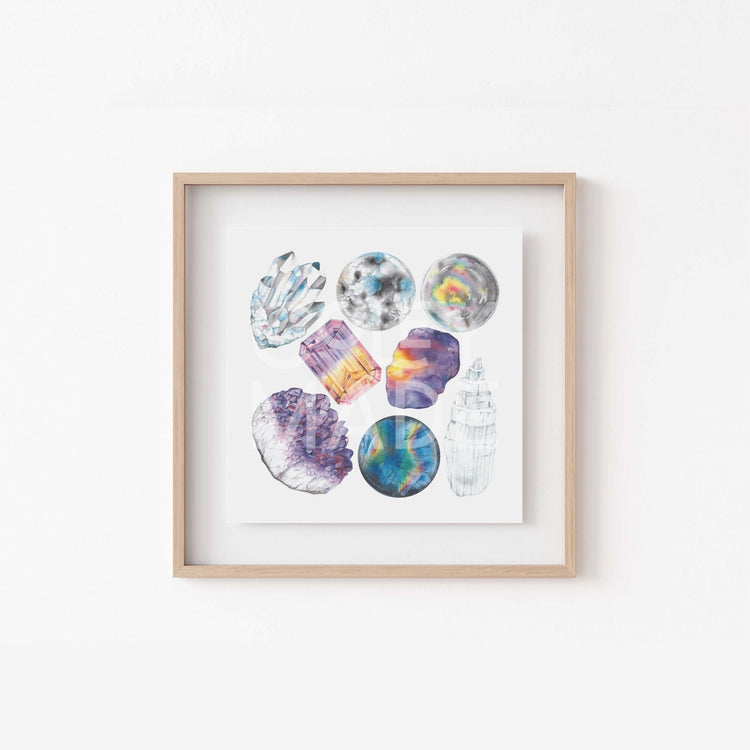 a white wall with a wooden frame holding a picture of the Crown Chakra Watercolor Crystal Art Print