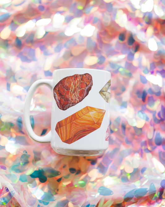 a white coffee mug with a picture watercolor crystals representing the 7 chakras