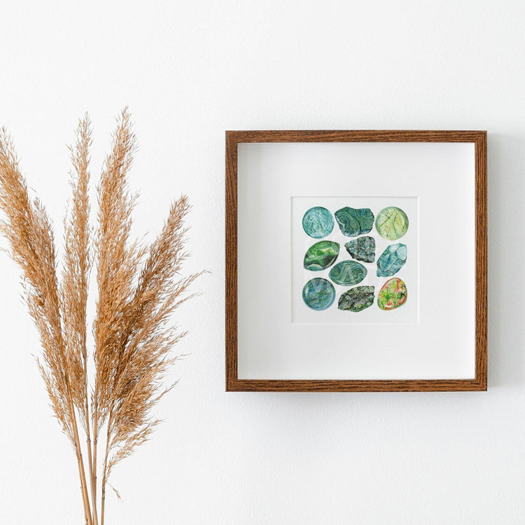 a picture of the Heart Chakra Watercolor Crystal Art Print hanging on a wall next to a plant