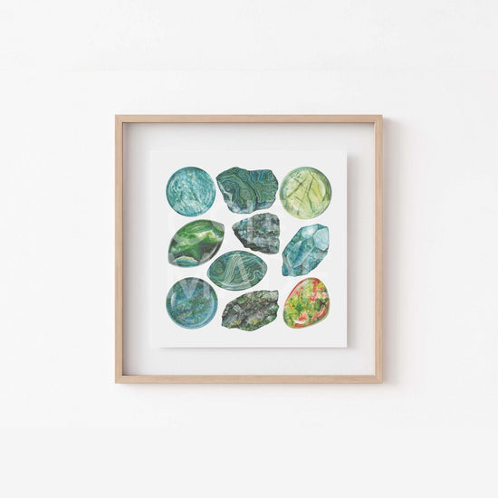 a white wall with a wooden frame holding a picture of heart chakra Watercolor Crystal Art Print