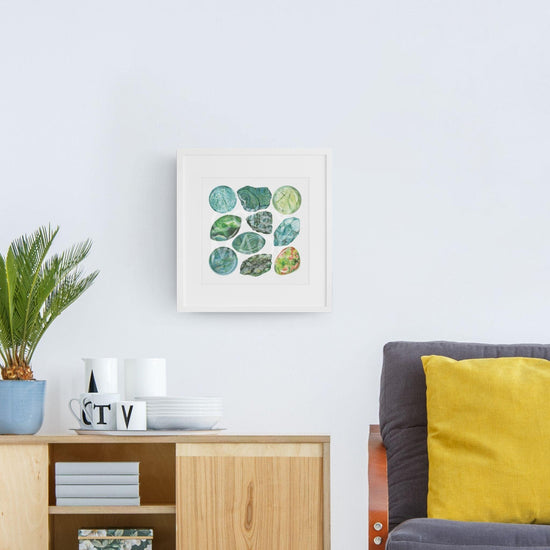 a living room with a couch and a table with Heart Chakra Watercolor Crystal Art Print hanging on the wall