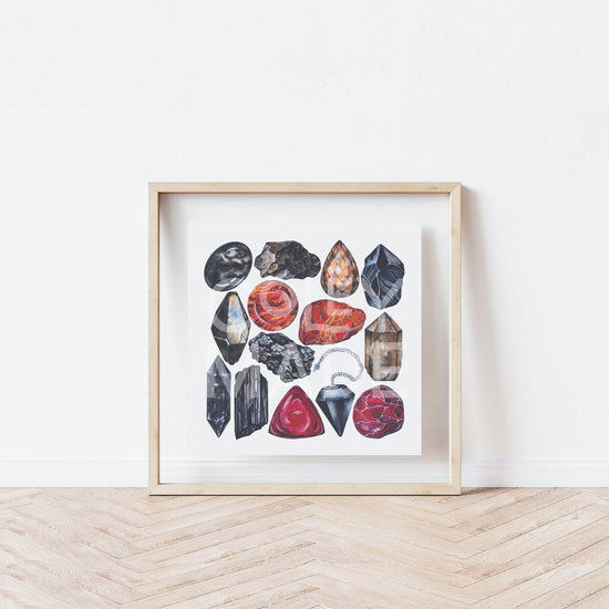 a white wall with a wooden frame holding a picture of the root Chakra Watercolor Crystal Art Print
