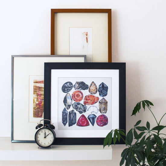 a picture of Root Chakra Watercolor Crystal Art Print and a clock on a shelf