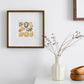 Solar Plexus Chakra Watercolor Crystal Art Print hanging on the wall next to a white vase on a table