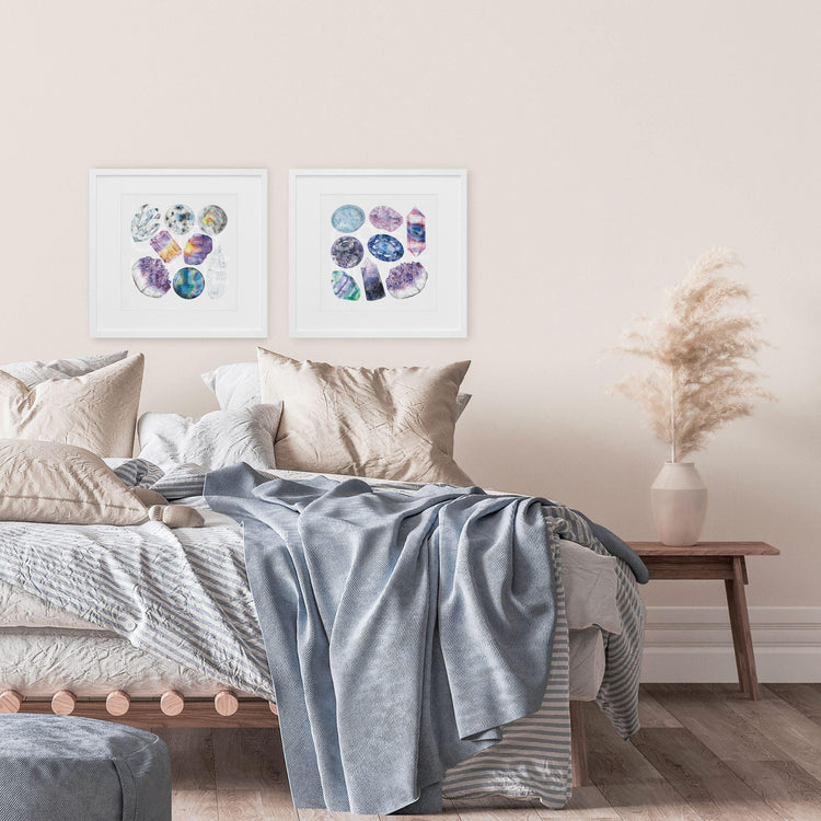 a bedroom with a bed and two Chakra Watercolor Crystal Art Prints on the wall