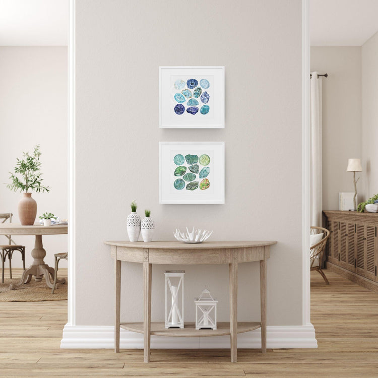 a living room with a table and two Chakra Watercolor Crystal Art Prints on the wall