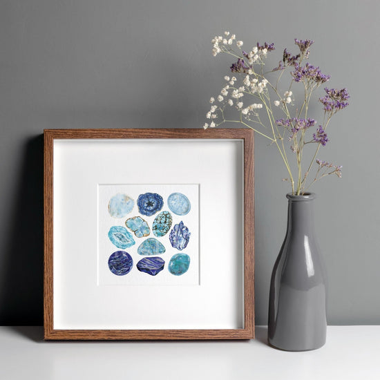 a Throat Chakra Watercolor Crystal Art Print of a vase with flowers in it next to a picture frame